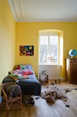 A children's room painted yellow in an apartment in a period building