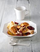 Braised chicken with prunes and beetroot on plate