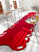 Red felt rug on surface with chairs