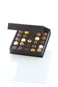 Chocolates in box on white background