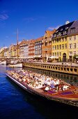Excursion boat Hustle and bustle at Nyhavn in Copenhagen, Denmark
