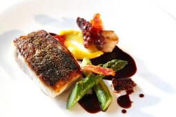 Close-up of sea bass, octopus and chorizo terrine with mandarin peel puree on plate