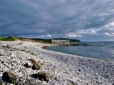 View of Kelpstore ruins surrounded with rocks on Rathlin Island coast, Ireland, UK
