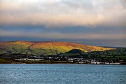 View of green pastures and village at Antrim coast, Ireland, UK