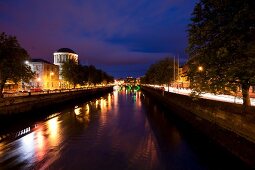 View of illuminated Four Courts and River Liffey at night, Dublin, Ireland, UK