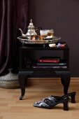 Side table with oriental tray and tea set on black table