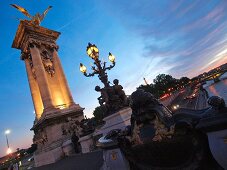 Pont Alexandre III over Seine river in night lights in Paris, France