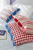 Striped and checked pillow cases on checked sheet