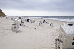 View of Westerland beach with hooded beach chairs in Sylt, Germany