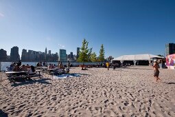 Tourists relaxing on Water Taxi Beach in Queens, New York, USA