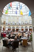 People sitting at restaurant of Havenwelten shopping mall in Bremerhaven, Bremen, Germany