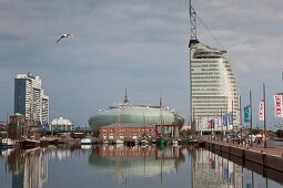 Reflection of harbour and Atlantic Hotel Sail City in sea at Bremerhaven, Bremen, Germany