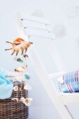 Wind chimes made of seashells hanging from chair back