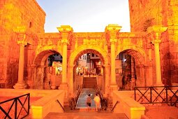 People at Hadrian's Gate at dusk in Antalya, Turkey