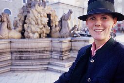 Portrait of woman with freckles wearing hat, Residence Square, Salzburg, Austria