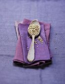 A spoonful of buckwheat on a purple napkin
