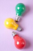 Red, yellow and green bulb on pink background