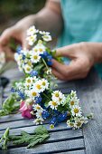 A garland of flowers being tied