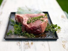Close-up of Argentinean steak with herbs and olive oil marinade on plate