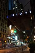 Car parked outside Night Hotel Times Square at night in New York, USA