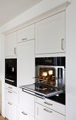 White open steam oven integrated in wall cabinet