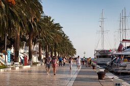 Tourists at Hvar harbour waterfront in Croatia