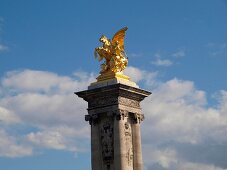 Statue at top of the column at Pont Alexandre III bridge, Paris, France