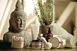 Close-up of table with Buddha's showpiece and other products