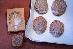 Bärentatzen (madeline-style cakes) being made: cakes being removed from moulds