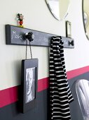 Picture frame and striped cloth hanging on hook