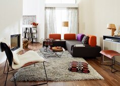 Modern furnishings in living room with corner sofa & long-pile rug