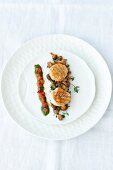 Close-up of fried scallops with chanterelles and red pepper on plate