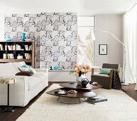 Living room with sofa, carpet, table and patterned wallpaper