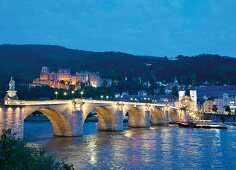 Illuminated Karl-Theodor-Bridge at evening in Heidelberg, Germany