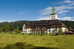 View of Hotel Schloss Elmau, meadows and mountain, Upper Bavaria, Germany