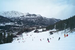 View of skiers skiing downhill in Hemsedal, Norway