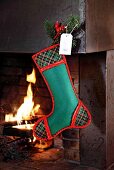 Green stockings made of felt hanging on fireplace