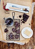 Biscuits being decorated with chocolate glaze