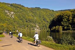 People cycling beside Saar loop in Mettlach, Saarland, Germany