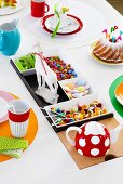 Bowl of candy on colorfully decorated dining table