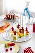 Fruit skewers on plate - table laid for child's birthday