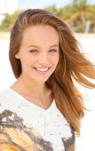 Portrait of beautiful woman wearing white patterned top, smiling