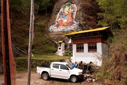 View of rock with Buddha painting and meditation house in Thimpu, Bhutan