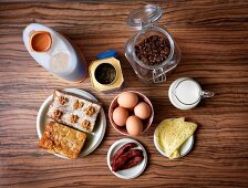 Compilation of various foods and beverages on wooden table, overhead view