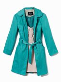 Close-up of turquoise trench coat over white dress on white background