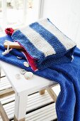 A knitted, blue and white striped make-up bag