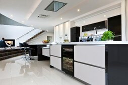 View of open kitchen with narrow kitchen island in black and white