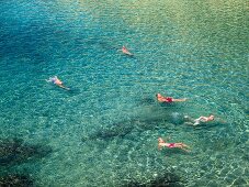 People enjoying in water at Costa Paradiso at North Coast of Sardinia, Italy