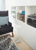 Rocking chair, record player, cabinet and shelf in living room