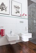 White toilet and bidet in bathroom